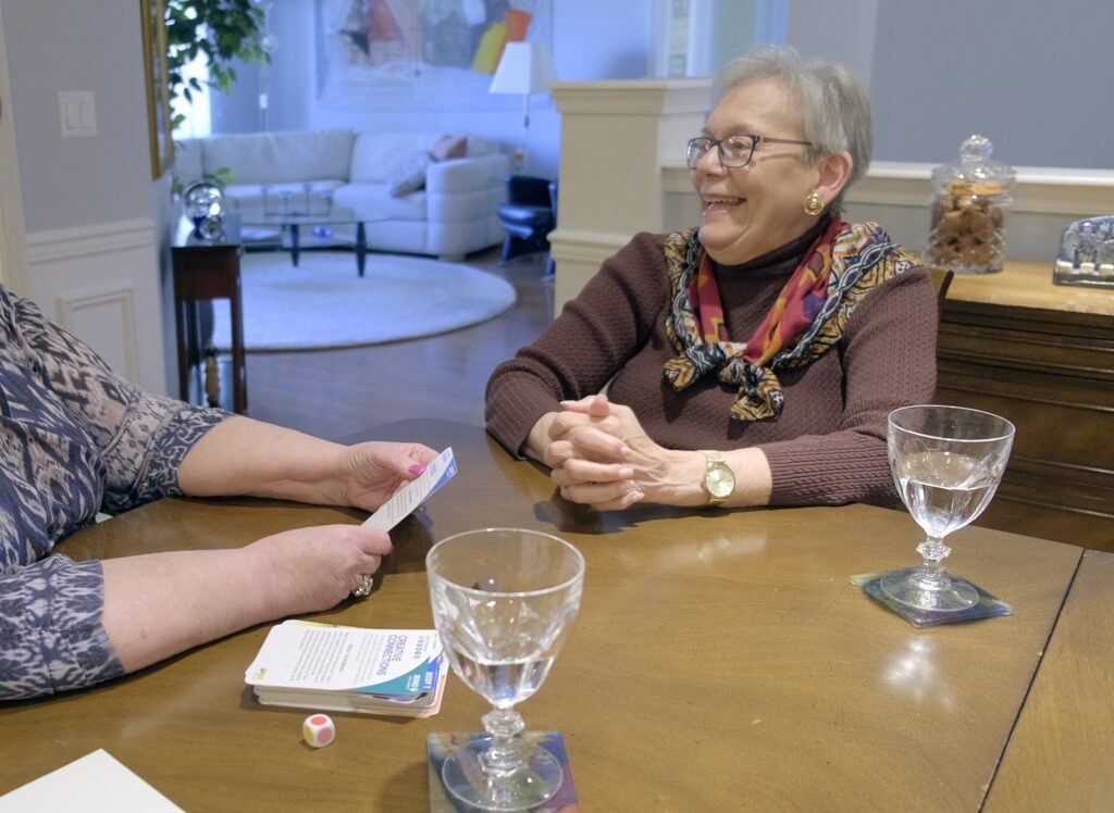 two women speaking at a table