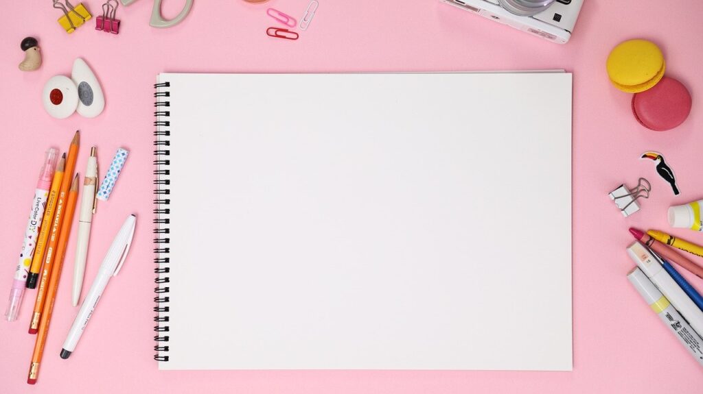 a blank notebook and pencils
