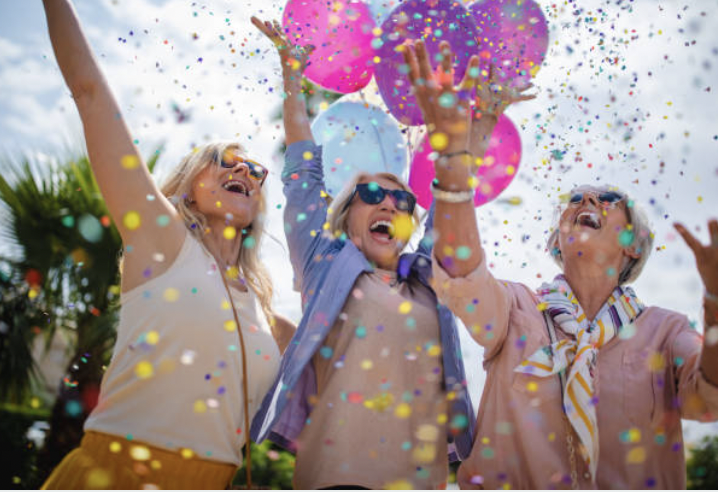Three women with balloons at a party